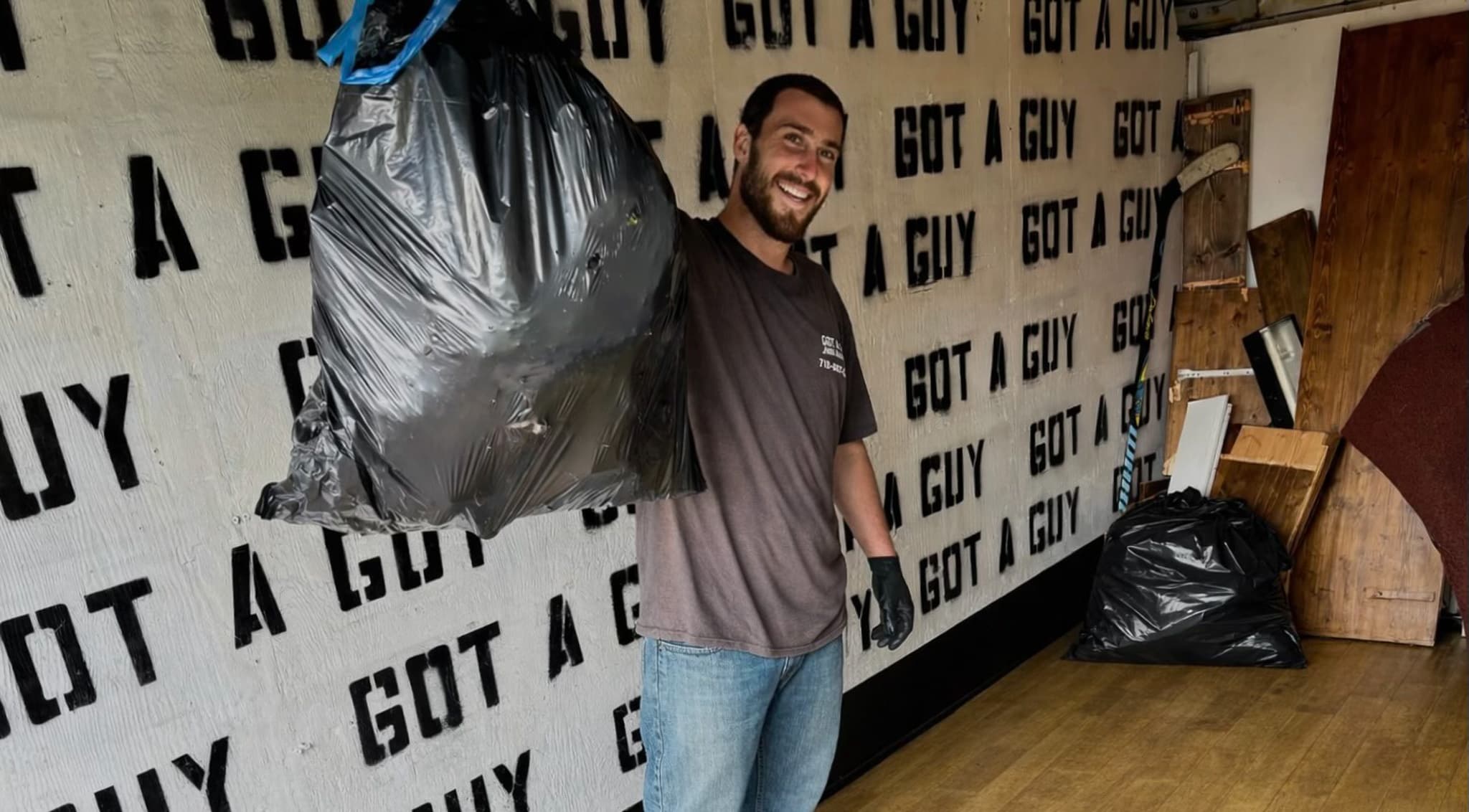 Got A Guy junk removal worker standing beside a branded truck